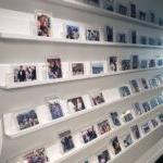A wall with photos of important moments in the lives of 员工